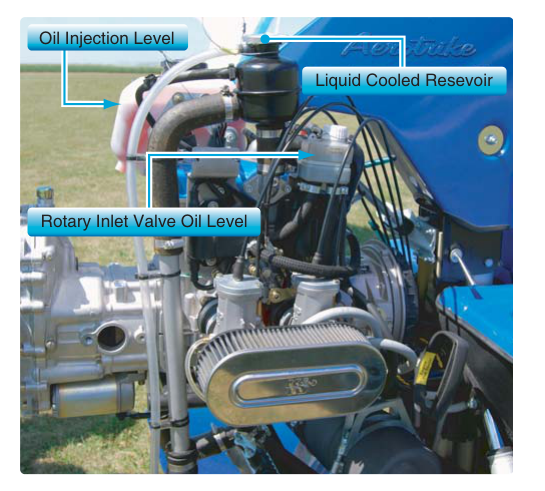 Two-stroke engine showing oil injection reservoir and level, rotary inlet valve reservoir and level, and liquid cooled reservoir for checking coolant levels.