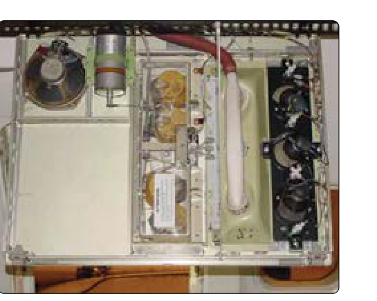 An oxygen generator mounted in place in an overhead passenger service unit of an air transport category aircraft.