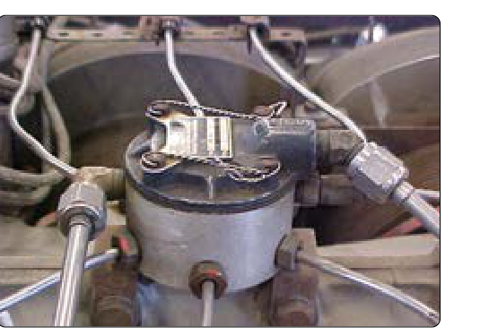 A fuel distribution manifold for a fuel-injected engine.