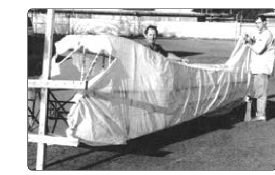 A custom-fit presewn fabric envelope is slid into position over a fuselage for the envelope method of fabric covering. Other than fitting, most steps in the covering process are the same as with the blanket covering method.